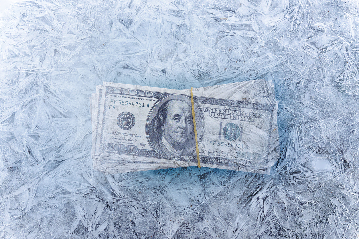 a stack of 100 dollar bills are banded together and frozen in ice. BetMGM Freezes All Promo Offers in NY. The operator stopped spending money to acquire players in New York in May, citing the ludicrously high NY tax rates.