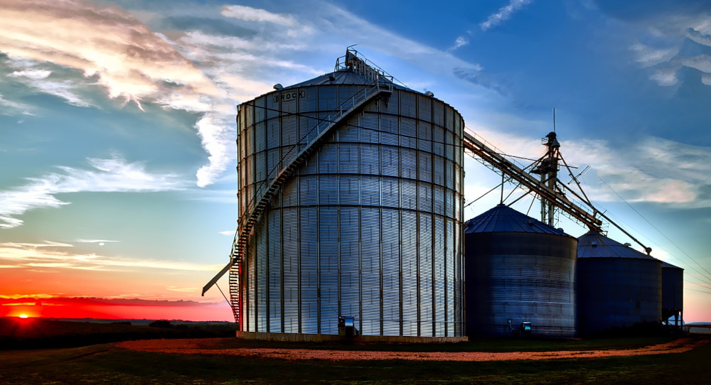 Iowa field at sunset, pretty oranges and blues behind grain silos on a farm. January was a great month for some and terrible for others. FanDuel was up 85% while five sportsbooks lost revenue, including IA's newest sports betting site.