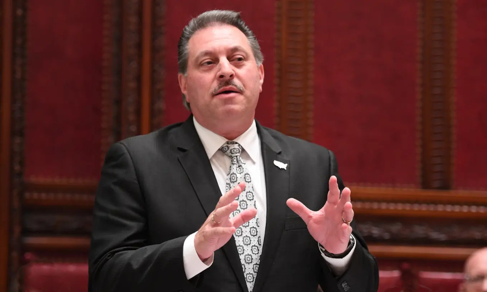 Sen. Joseph Addabbo Jr. is seen at a legislative meeting. he has grey hair and mustache. wearing a sharp pinstripe suit with a yellow paisley tie. Sen. Joseph Addabbo Jr. is hopeful that online poker & casino can pass next year.